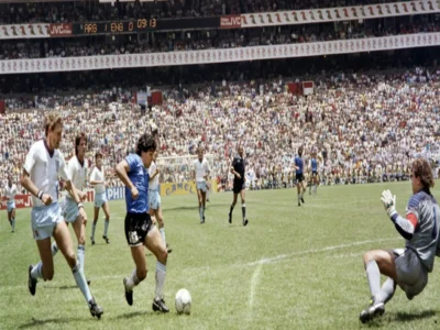 Historic Argentina vs England 1986 World Cup action showing a legendary solo goal moment near the penalty area.