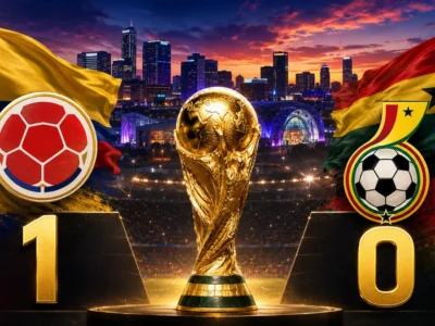 Colombia beat Ghana 1-0 in the 2026 FIFA World Cup as the Colombia and Ghana flags and crests flank the trophy with the score displayed over a Kansas City backdrop.