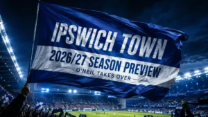 Ipswich Town 2026/27 season preview featured image with a blue-and-white flag waving inside a floodlit stadium and the headline O’Neil Takes Over.